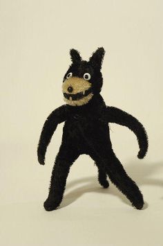 a stuffed animal that is black and brown