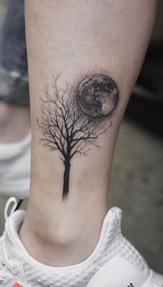 a person with a tree tattoo on their leg