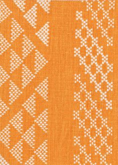 an orange and white pattern on fabric