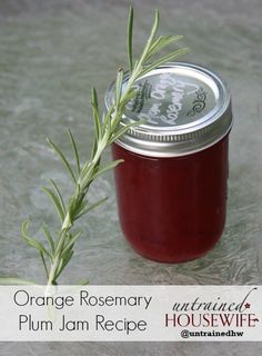 an orange rosemary plum jam recipe in a jar with a sprig of rosemary