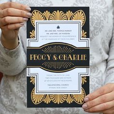 a woman holding up a black and gold wedding card with the words fancy & creatie on it