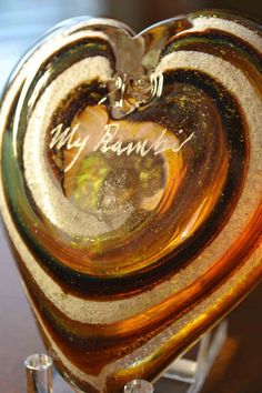 a heart shaped glass vase sitting on top of a table