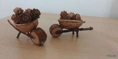 two small wooden wheels with pine cones in them