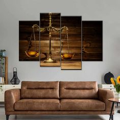 a living room with a couch, table and two golden scales on top of it