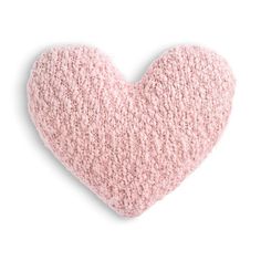 a pink heart shaped pillow on a white background