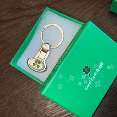 a green box with a keychain in it