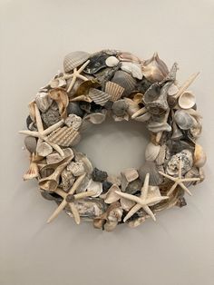 a wreath made out of seashells on a wall