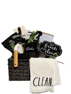 a basket filled with personal care items and cleaning cloths next to a dish towel