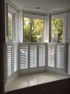 an empty bay window with shutters open