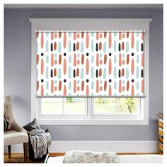 a bedroom with an orange and blue patterned roman blind