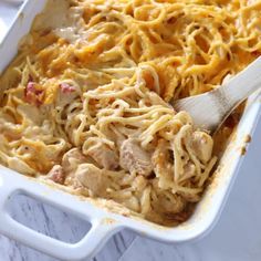 a casserole dish with chicken and noodles in it, ready to be eaten