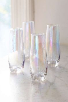 four glasses sitting on top of a table