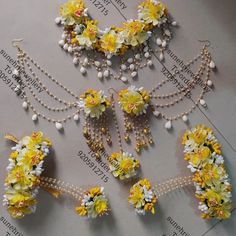 several pieces of jewelry with flowers and pearls