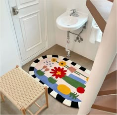 a bathroom with a rug on the floor next to a sink