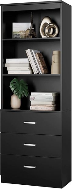 a black bookcase with three drawers and a plant