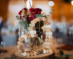 a table with wine corks and flowers on it