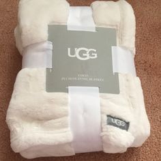 the ugg blanket is folded up on the floor