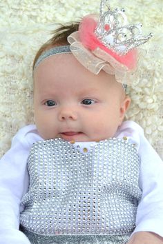 a baby with a tiara on her head