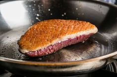 a piece of meat sitting in a frying pan