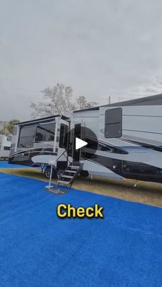 an rv parked on the side of a road next to a blue carpeted parking lot