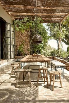 an outdoor dining area with wooden tables and chairs