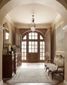 an arched doorway leads to a large foyer