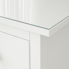 a close up view of a white cabinet door