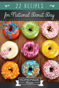 four different colored donuts with sprinkles are on a wooden table top