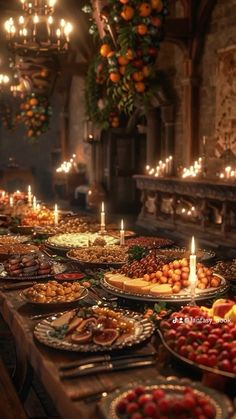 a long table filled with lots of food and lit candles in the middle of it