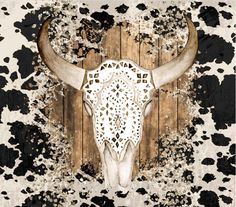 a cow's skull on a wooden wall with black and white paint splatters