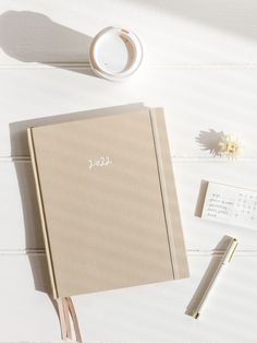 an open notebook sitting on top of a white table