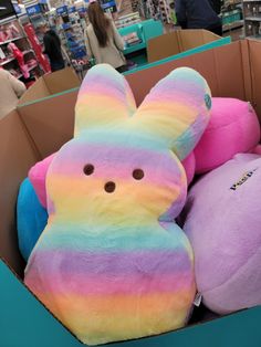 a box filled with lots of colorful stuffed animals in it's packaging at a store