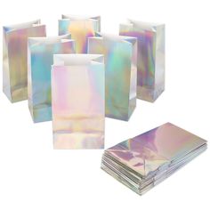 holographic paper bags are stacked on top of each other and one bag is empty