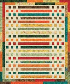 a quilt with many different colors and patterns on the front, including multi - colored strips