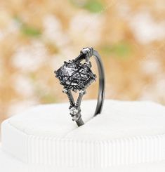 a diamond ring sitting on top of a white cake