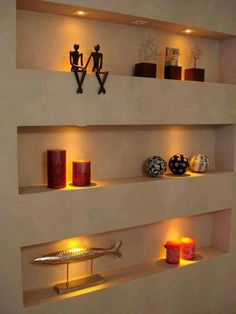 some shelves with candles and vases on them