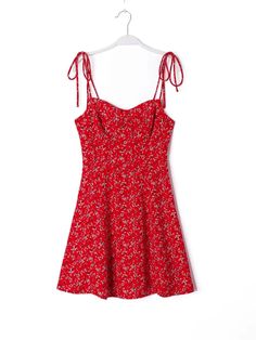 Eager to be donned on bright, sunny days, this dress is a true reflection of summer’s vibrancy. The red backdrop, speckled with tiny flowers, captures the essence of joy and energy. The tie straps allow for a personalized fit, leading down to a bodice that offers both comfort and a slimming effect. The skirt cascades into a carefree flow, perfect for those moments when you find yourself dancing to your favorite song or laughing with friends at a backyard gathering. This dress is a piece of weara