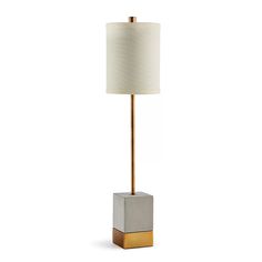 a lamp that is sitting on top of a table next to a white shade light