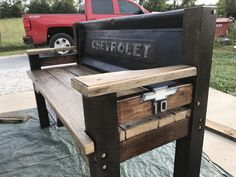 a bench made out of an old truck bed with the word chevrolet painted on it