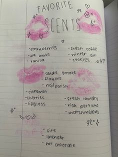 an open notebook with writing on it and pink lipstick drawn on the pages in different languages