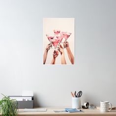 two hands holding up pink martini glasses over a white background poster - print on wall