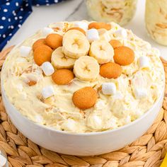 a bowl filled with bananas and marshmallows on top of a table