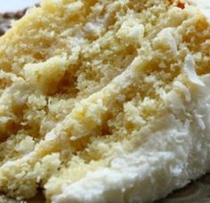 a piece of cake with white frosting on it sitting on top of a plate