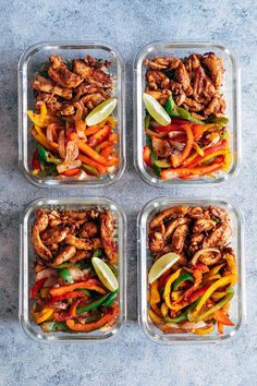 four glass containers filled with chicken, peppers and carrots next to lemon wedges