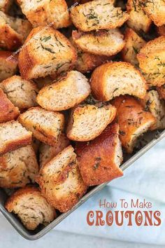 a pan filled with bread that has been cooked and is sitting on top of a towel