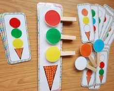 three wooden pegs with different shapes and colors next to each other on a table