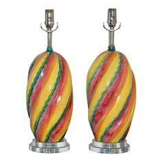 a pair of multicolored glass table lamps on chrome bases, each with a unique design