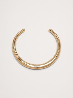 This sophisticated high-shine choker is hollow cast, then hand-finished and polished.  Curved ends make for easy wearability.  Layer it with a dangling pendant necklace for added style.  Gold-finished or silver-plated brass.  Made in India.  Diameter: 5. 75" Inner diameter: 4. 75" Opening 3" Gold Curve Necklace, Thick Gold Headband, Chunky Choker, Gold Cuffs, Staple Pieces, Banana Republic, Women's Accessories, Choker, Silver Plated