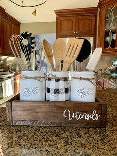 mason jars filled with utensils and wooden spoons