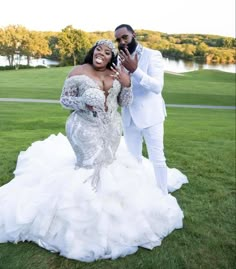 the newly married couple pose for a photo in their wedding gowns